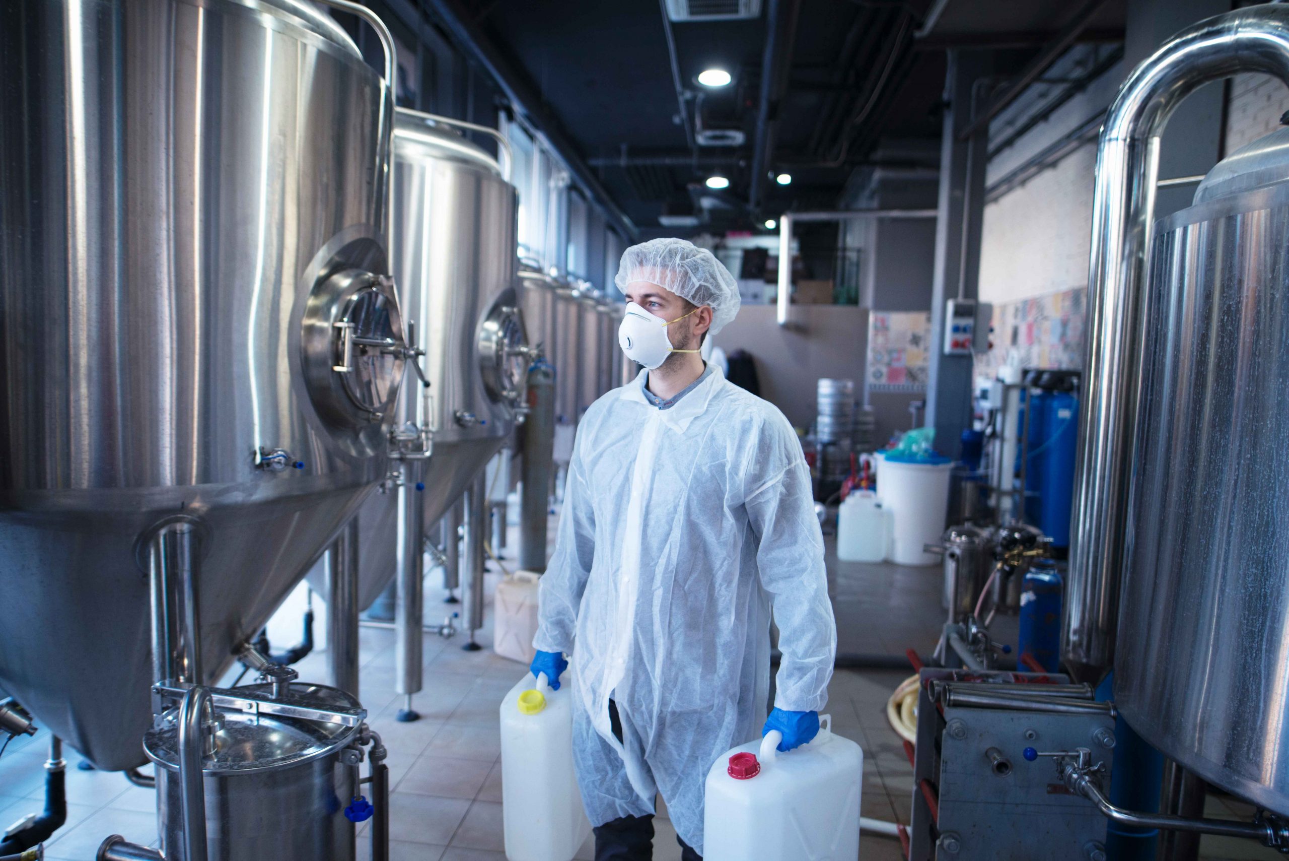 Man Handling Milk cans at Dairy Industry